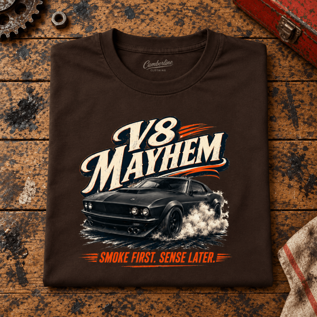 V8 Mayhem Muscle Fastback American Iron Graphic T-Shirt — Dark Chocolate, folded front main hero on a worn automotive workbench – car-ts-0070