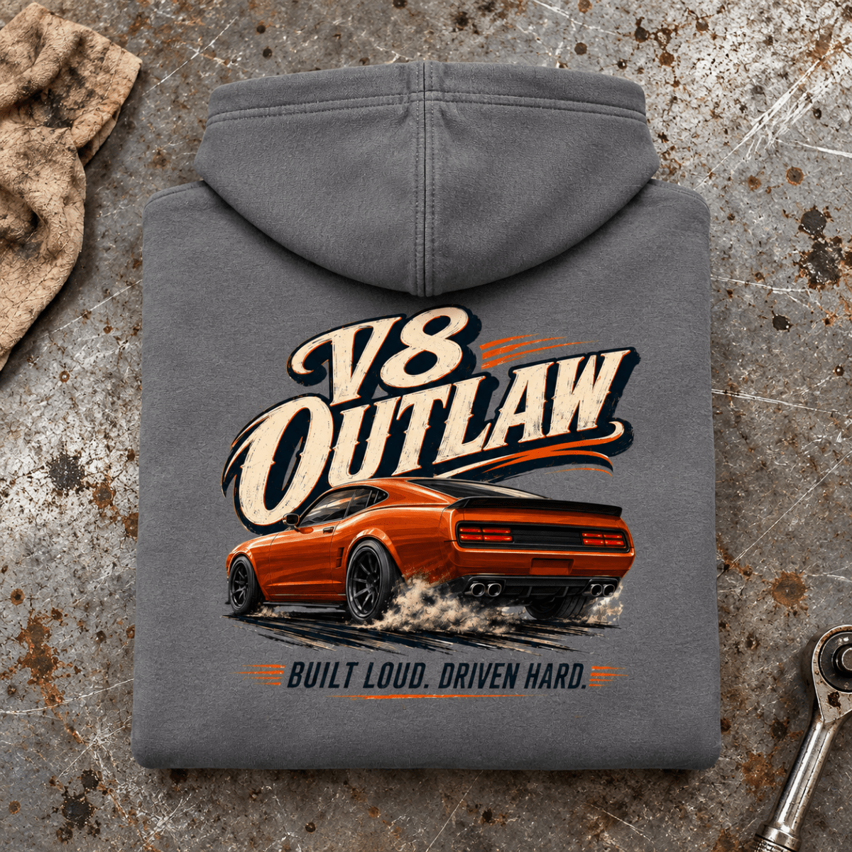 Folded charcoal V8 Outlaw American Iron Charcoal hoodie back on a workshop bench — car-hd-0087