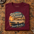 Muscle Car Graphic T-Shirt – Venice Cruise West Coast Boulevard, folded front main hero on a worn automotive workbench – car-ts-0067