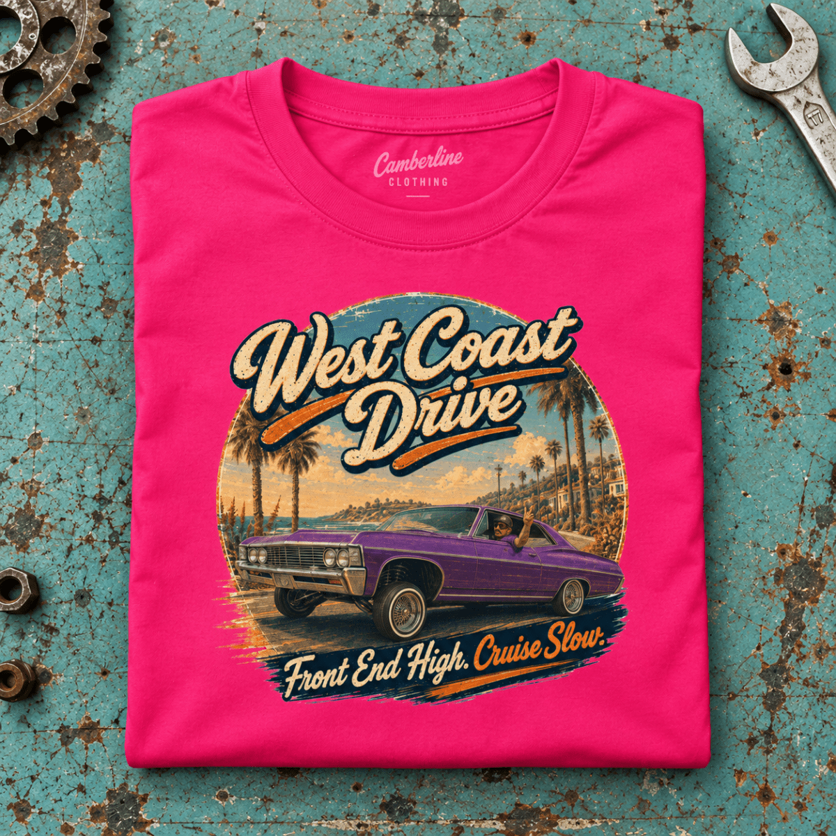 Lowrider Car Graphic T-Shirt – West Coast Drive, folded front main hero on a worn automotive workbench – car-ts-0068