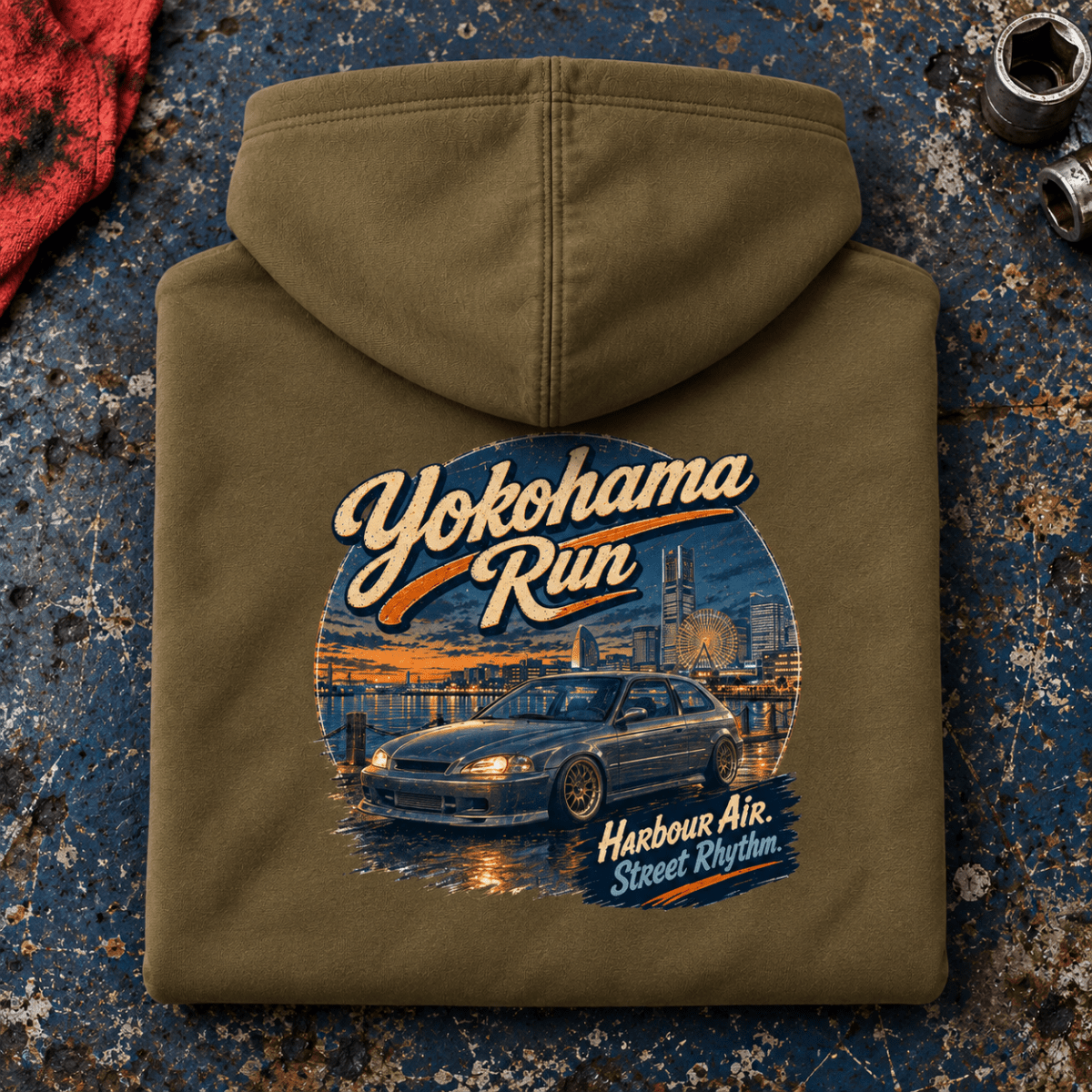 Hot Hatch Graphic Hoodie – Yokohama Run JDM, folded back main hero on a worn automotive workbench – car-hd-0062