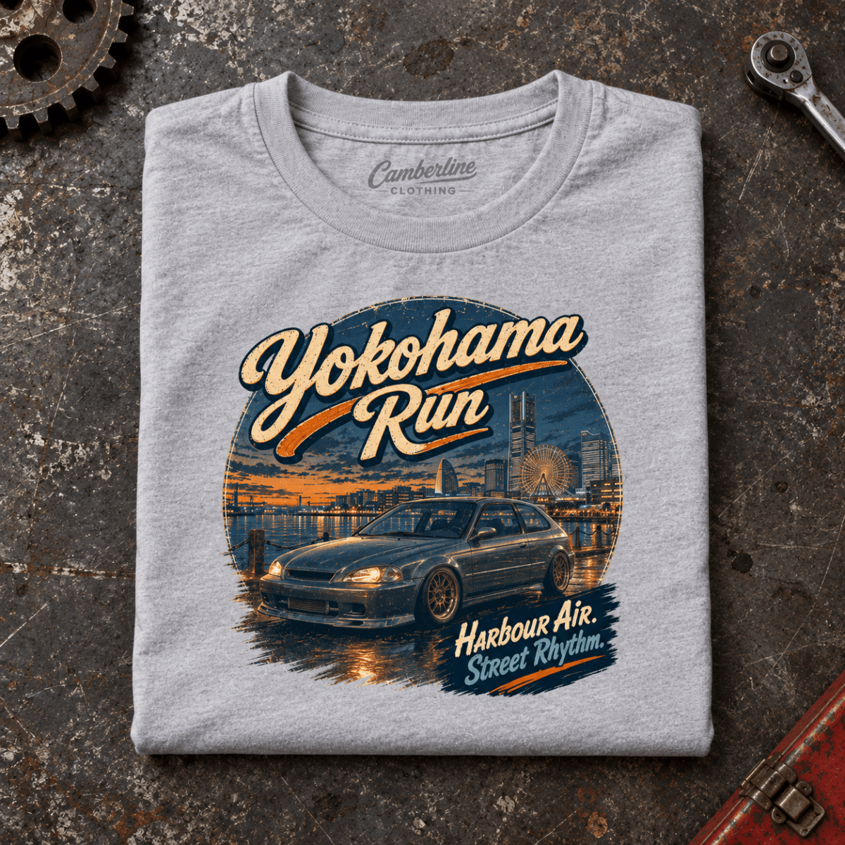 Hot Hatch Graphic T-Shirt – Yokohama Run JDM, folded front main hero on a worn automotive workbench – car-ts-0062
